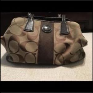 Medium sized Brown and Tan coach purse .
